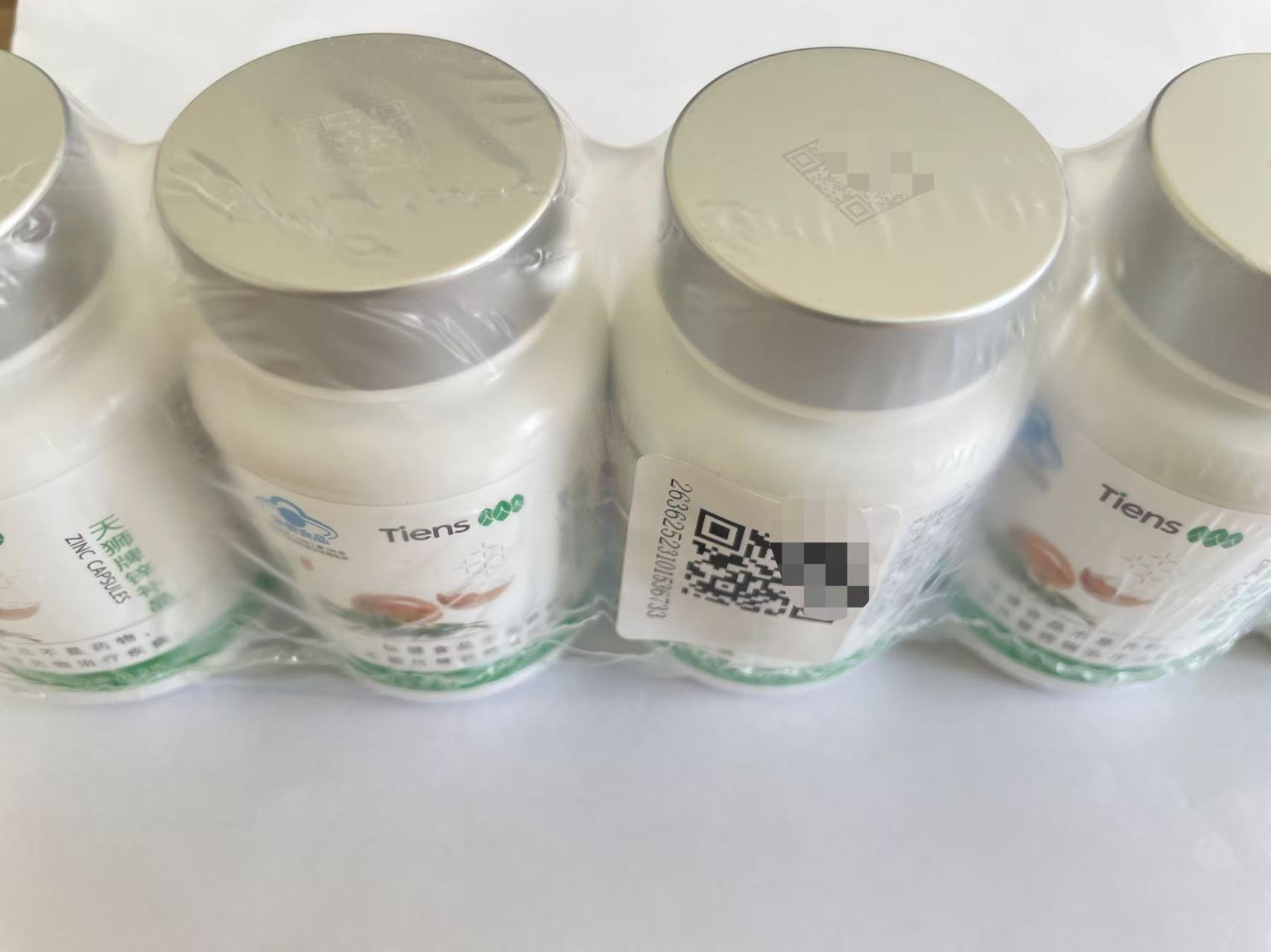 TIENS Zinc Capsules bottle set showing physical QR-code locations